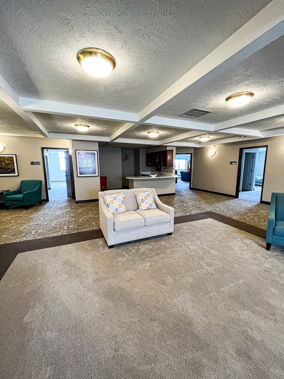 A spacious and modern living room with comfortable seating and a neutral color scheme.