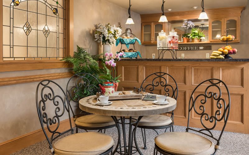 Cozy cafe interior with a round table and decorative elements.