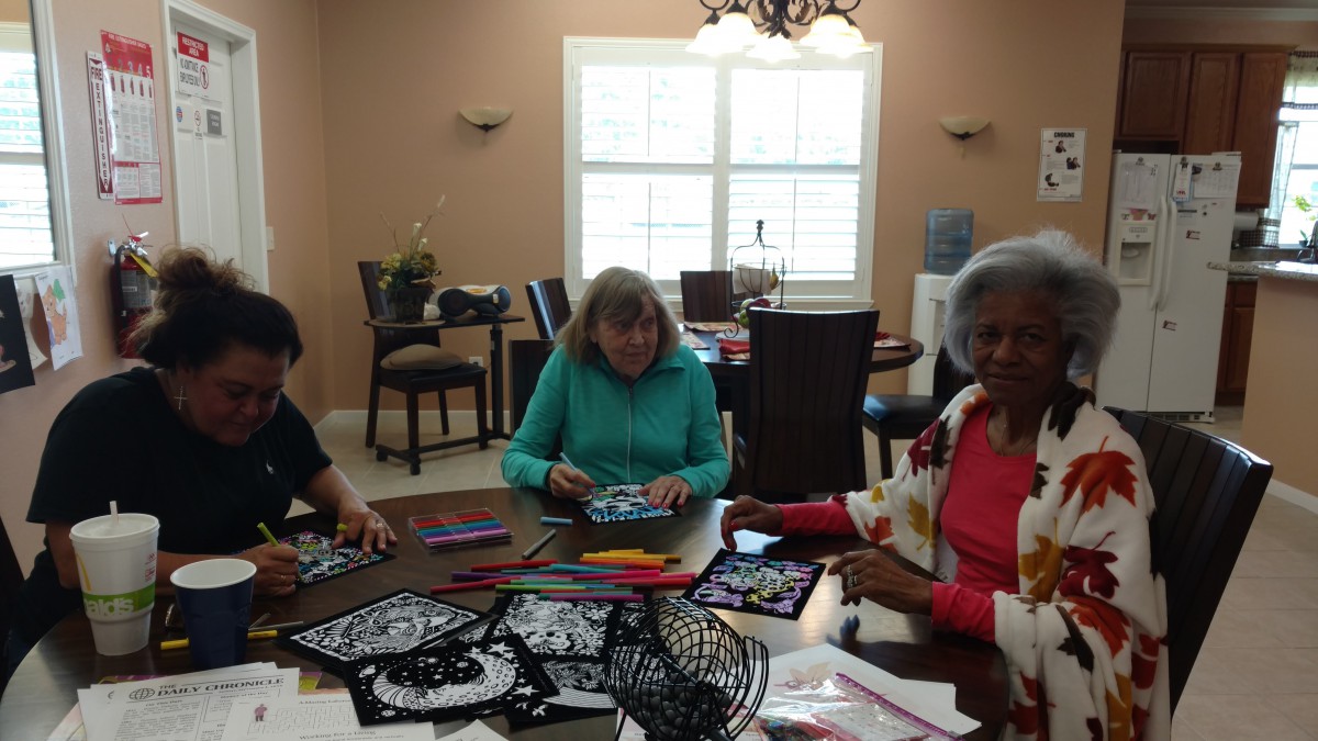 A group of adults engaged in a crafting activity indoors.