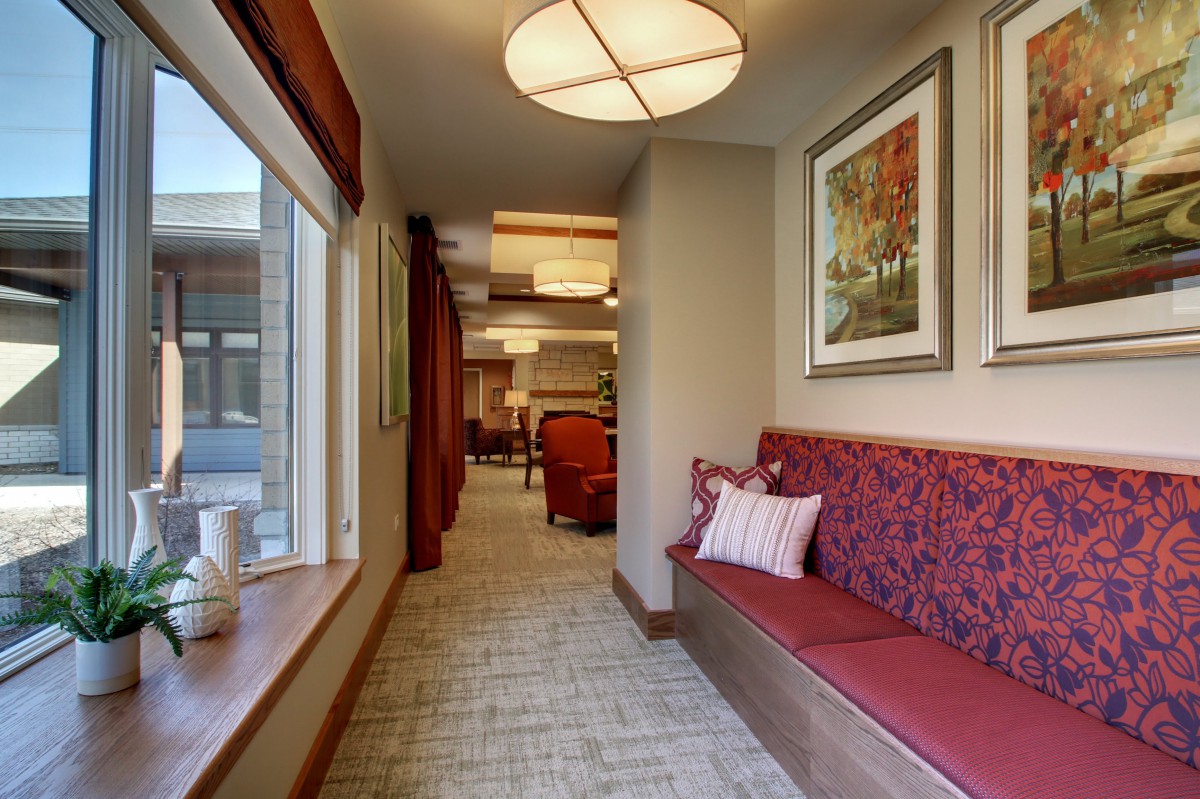 A cozy hallway with cushioned seating and artwork on the walls.