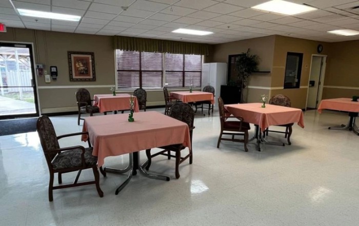 A quiet dining area with several tables and chairs arranged in a clean, well-lit space.