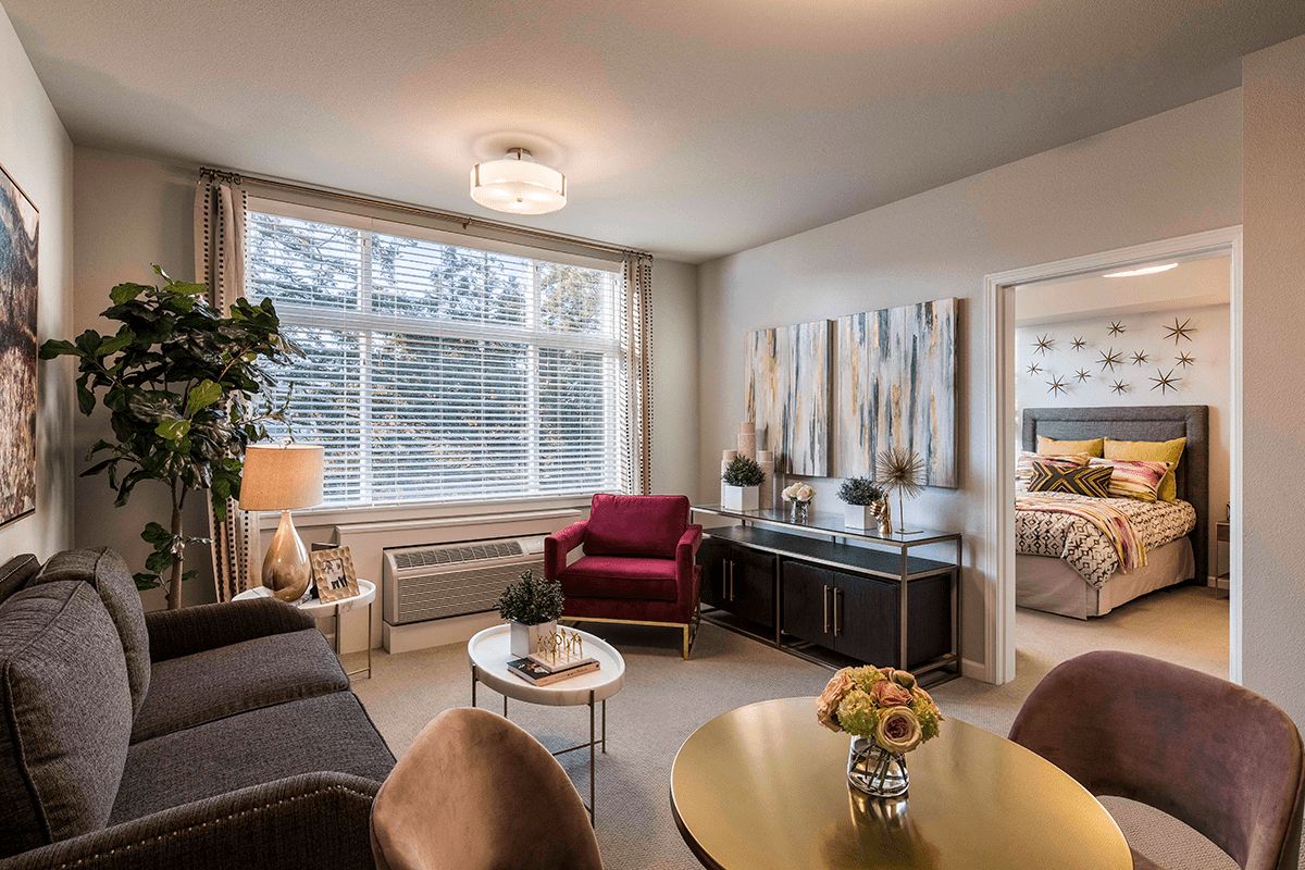 A cozy living room with modern furniture, ample natural light, and tasteful decor.