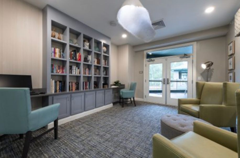 A modern library space with bookshelves and comfortable seating.