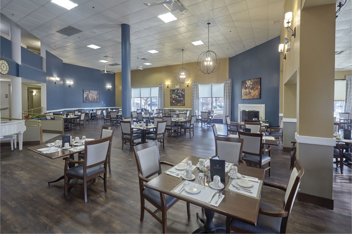 A modern restaurant dining area with neatly arranged tables and elegant decor.