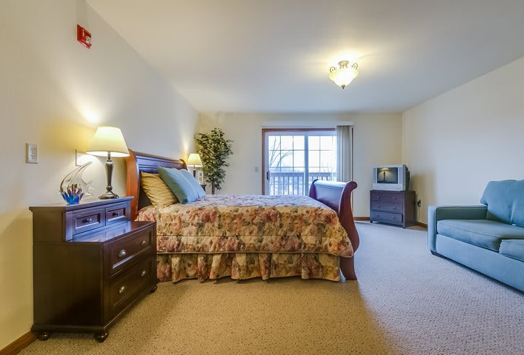 Cozy bedroom with classic furniture and warm lighting.