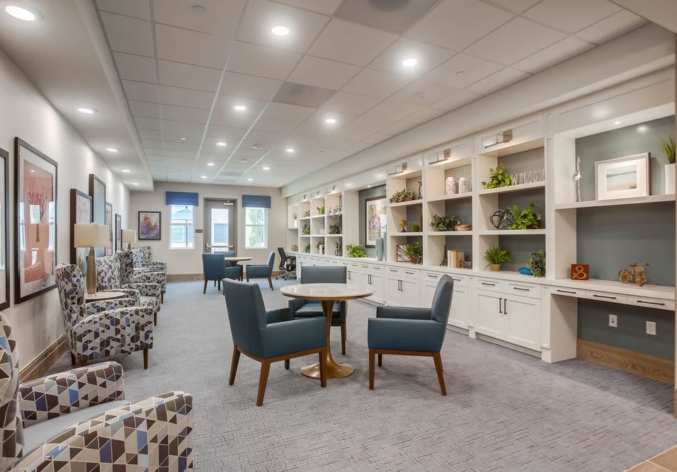 A modern living room featuring comfortable seating and built-in bookshelves.