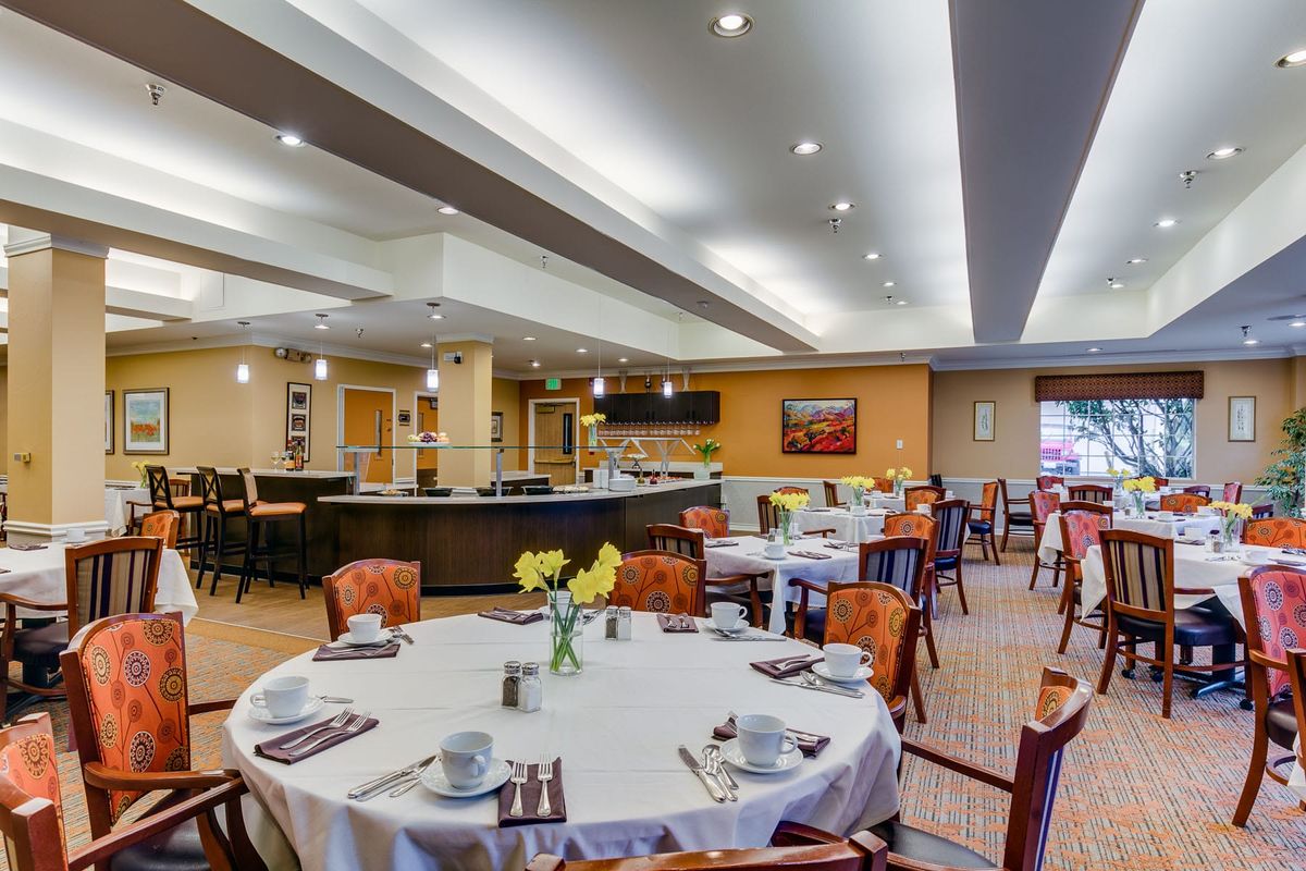 A modern restaurant dining area with neatly arranged tables and chairs.