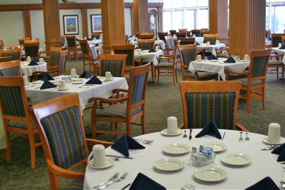 An elegant dining room with tables set for service.
