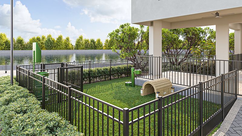 A small fenced dog park with green grass and play equipment.