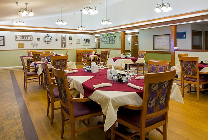 A well-decorated dining room with neatly arranged tables and chairs, ready for guests.
