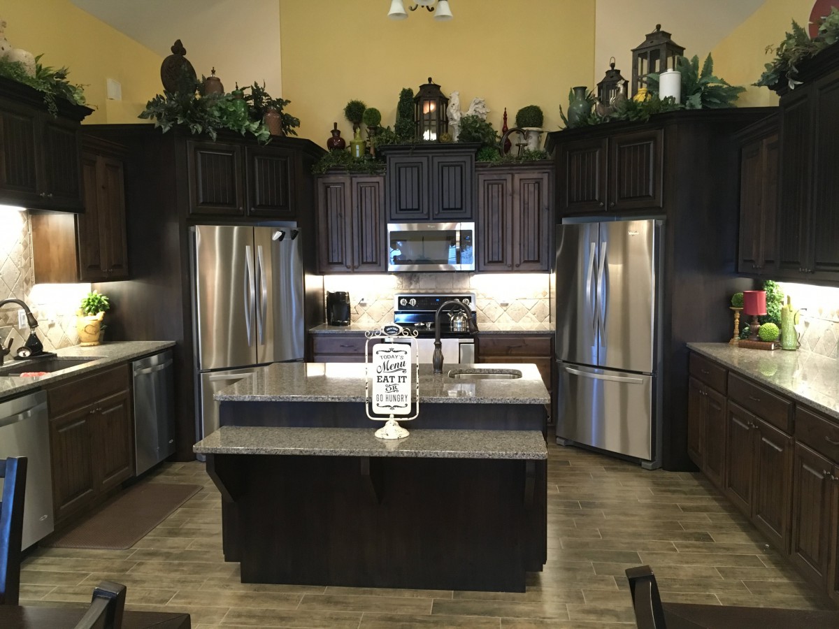Modern kitchen interior with stainless steel appliances and an island counter.
