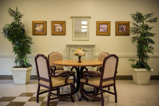 A cozy dining area with a round table and four chairs, adorned with decorative artwork on the walls.