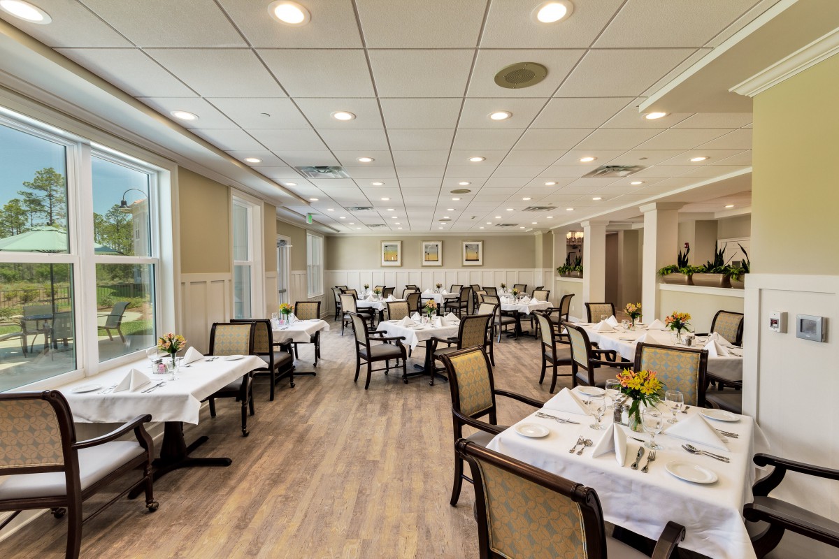 A spacious and elegantly designed restaurant dining area with neatly arranged tables and chairs.
