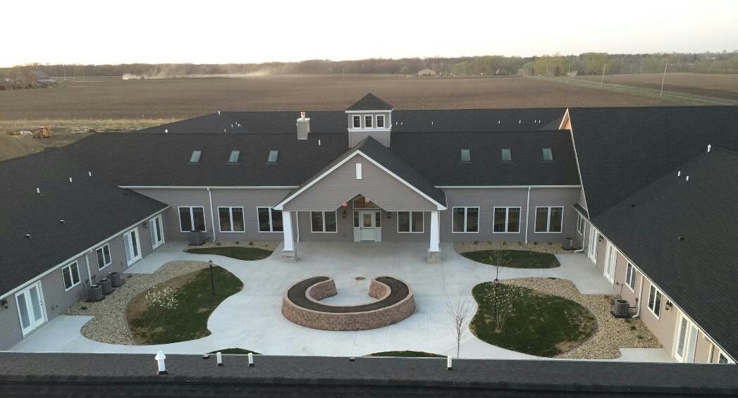 An aerial view of a modern building set in a rural landscape.