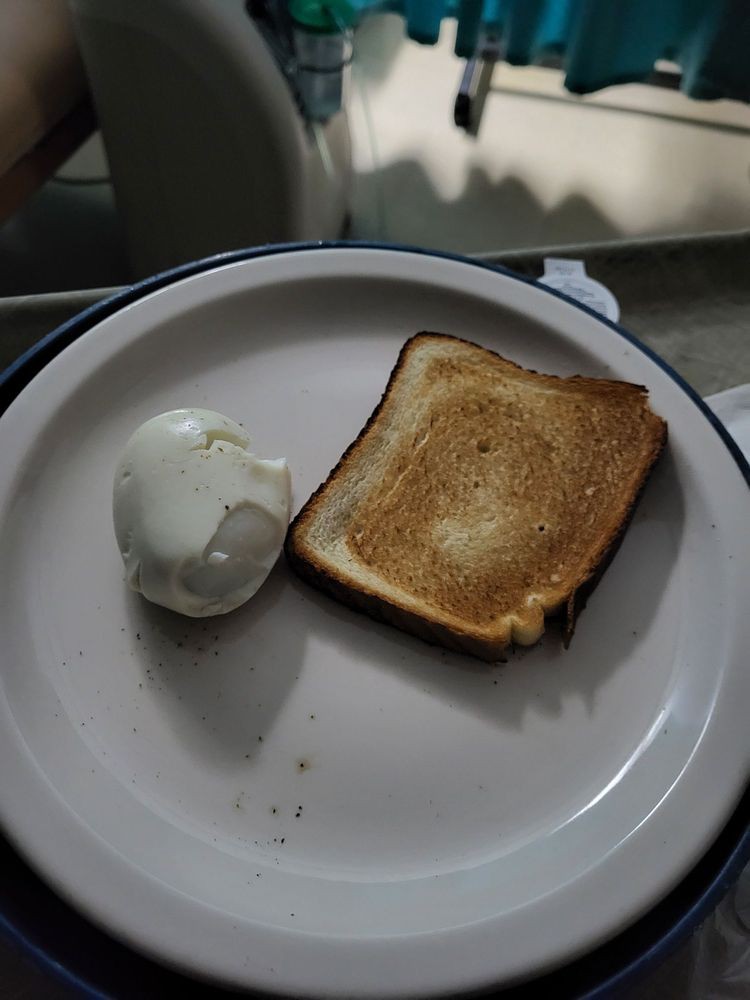 A plate with a piece of toast and a soft-boiled egg.