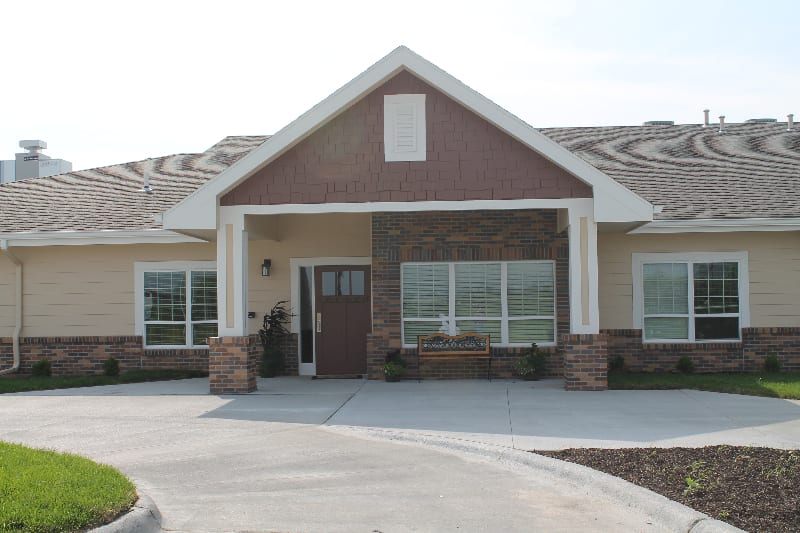 A suburban house with a brick exterior and large windows.