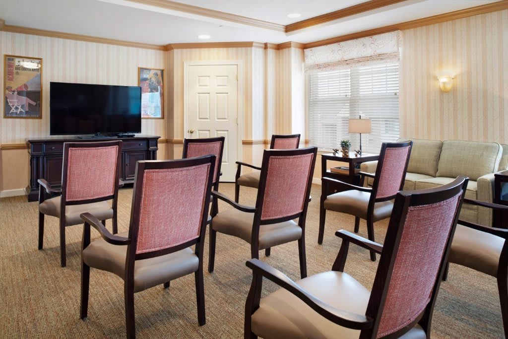 A small conference room with chairs arranged facing a television.