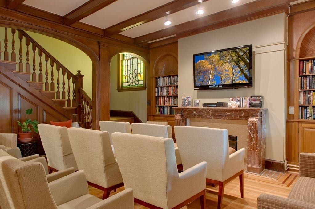 A cozy home theater room with comfortable seating and a large screen.