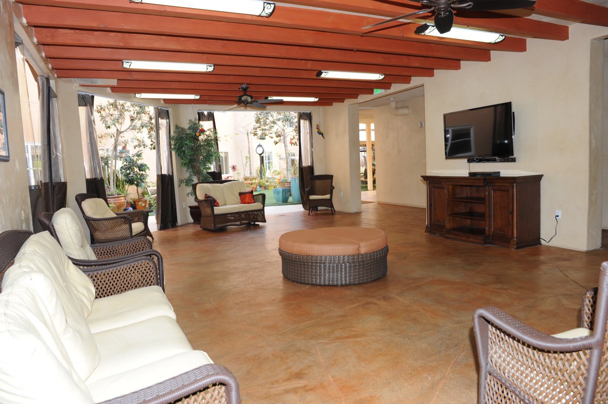 Spacious living room with modern furniture and ample natural light.