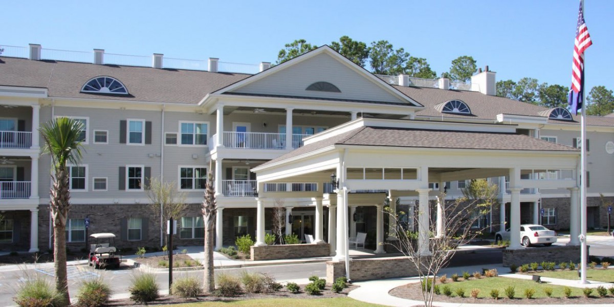 A large, multi-story residential building with a covered entrance and balconies.