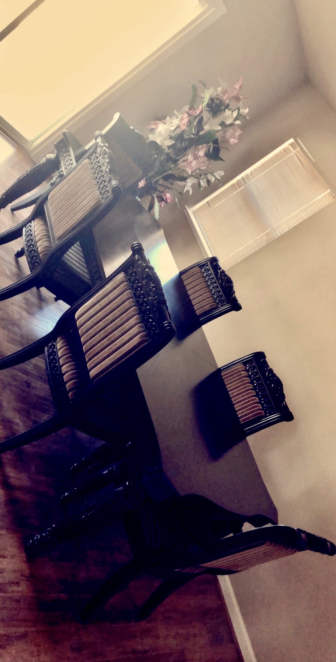 A set of wooden chairs around a dining table.