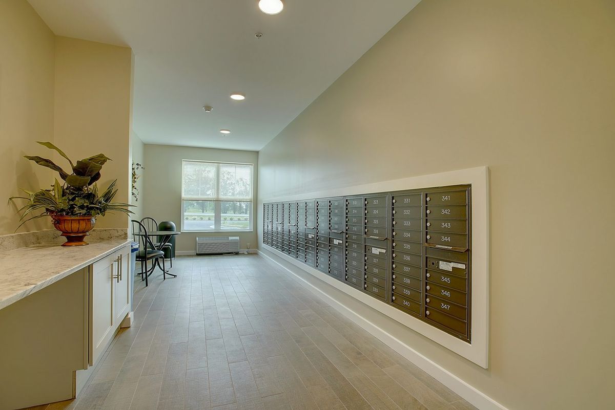A hallway with multiple mailboxes in an apartment building.