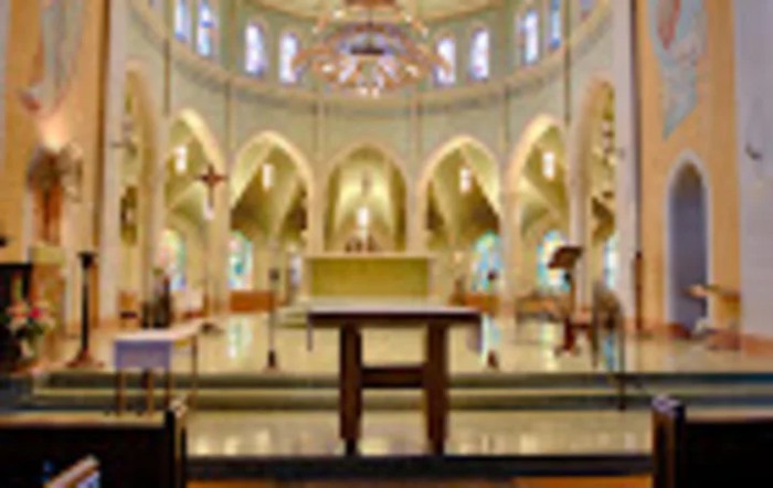 A beautifully decorated church interior featuring an altar and ornate architecture.