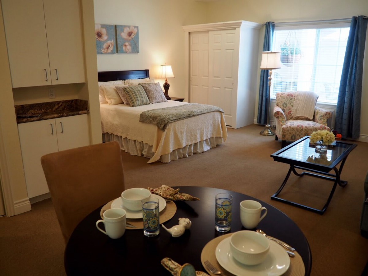 A cozy and elegantly decorated bedroom with a dining area.