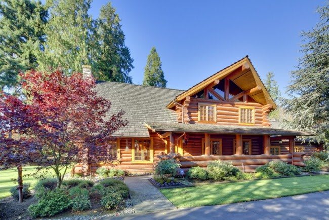 A beautiful log cabin nestled in a lush forest setting.