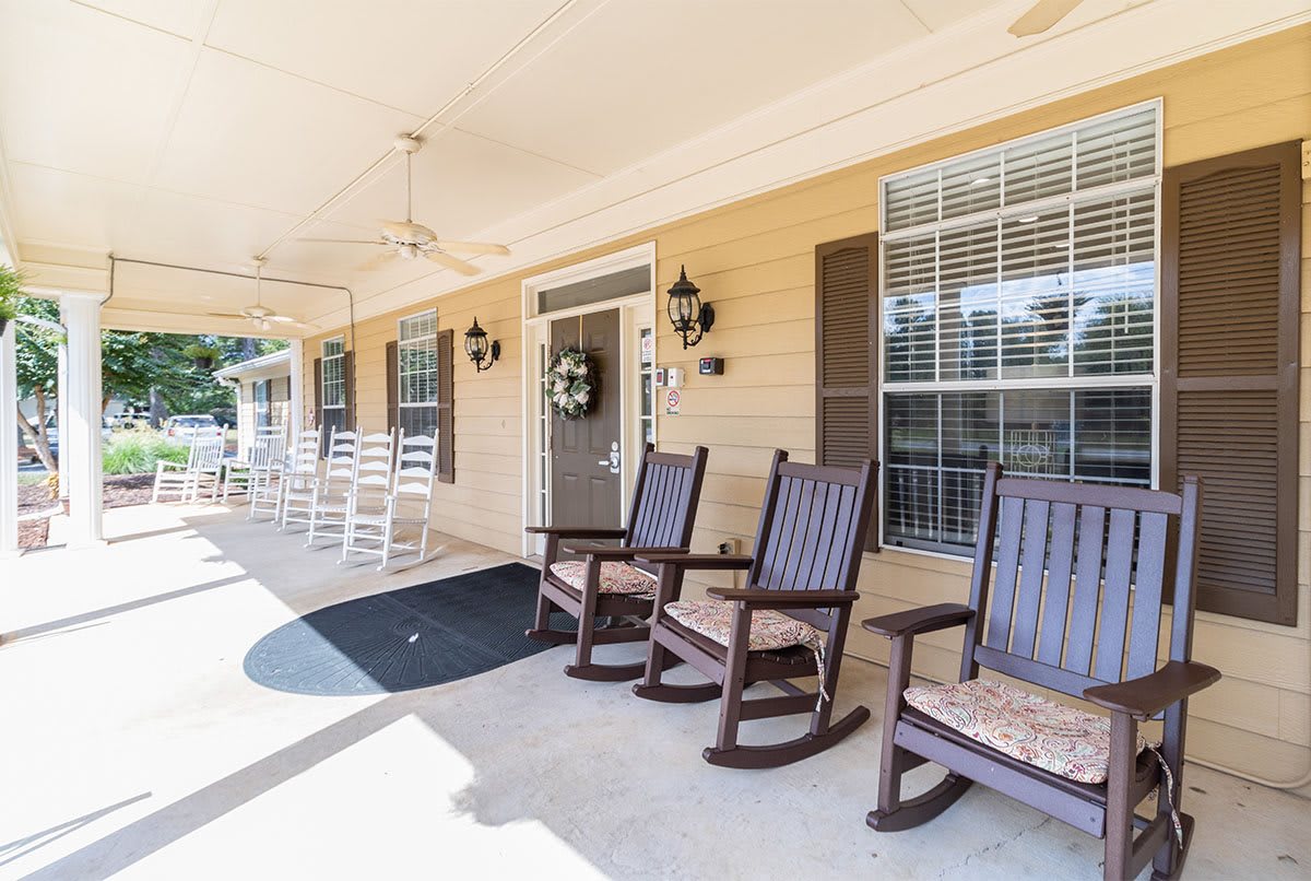 A sunny porch with rocking chairs and welcoming decor.