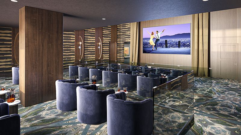 A luxurious indoor cinema with plush seating and a large screen, featuring decorative lighting.