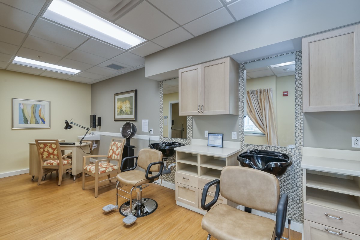 A well-equipped salon with chairs, mirrors, and hairdressing stations.