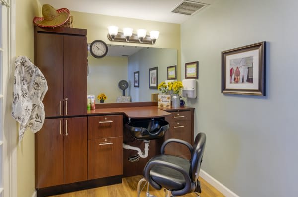 A well-organized hair salon interior with styling station and comfortable chair.