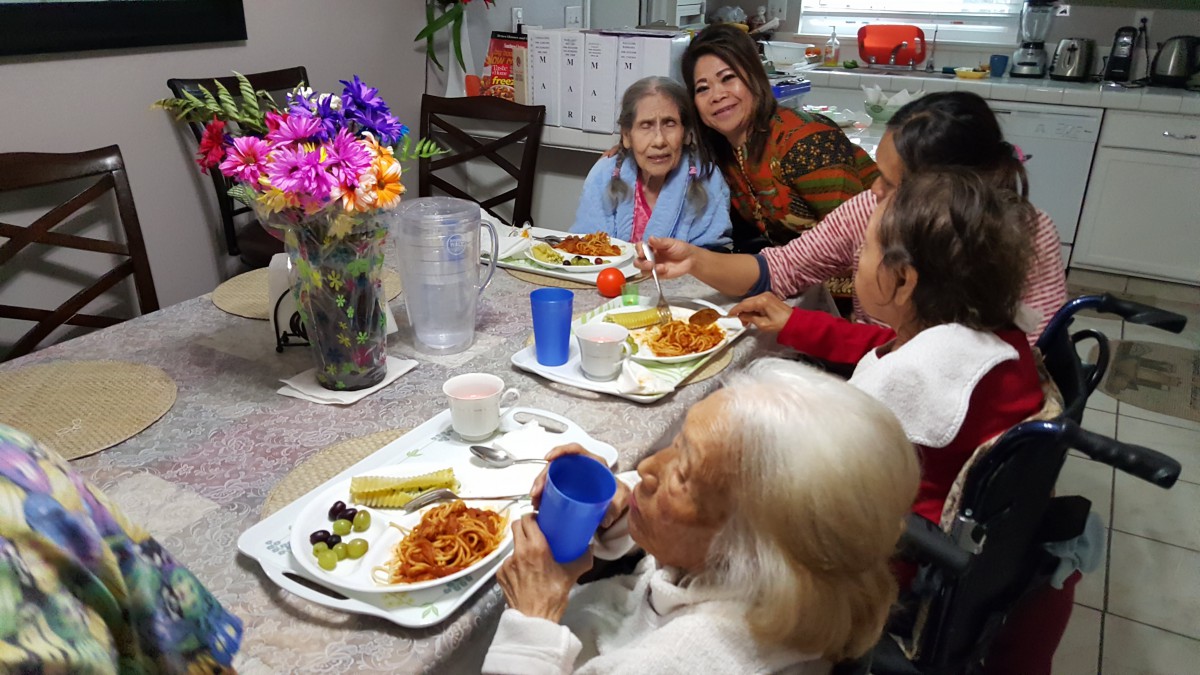 A family enjoying a meal together at the dinner table.