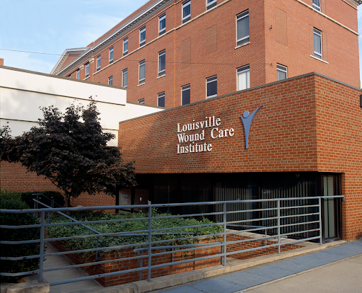 The entrance of a modern healthcare facility, showcasing its contemporary brick design and clear signage.