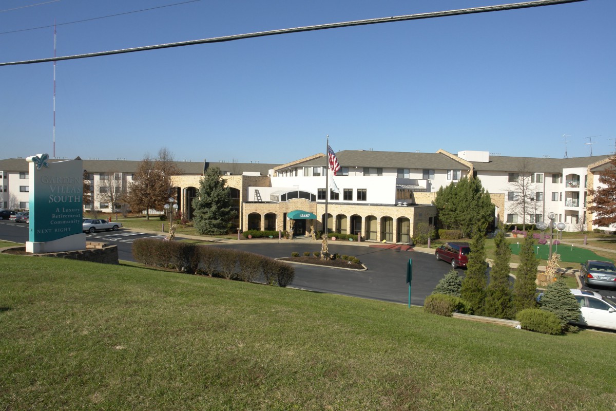 A healthcare facility with a landscaped exterior and parking lot.