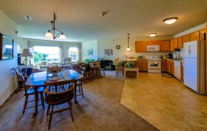 Spacious open-plan kitchen and dining area with modern furnishings.