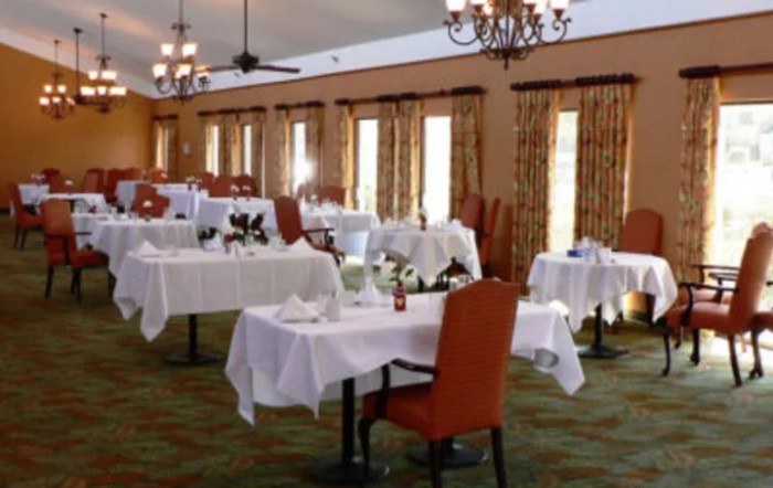 Elegant dining area with neatly arranged tables and chairs.