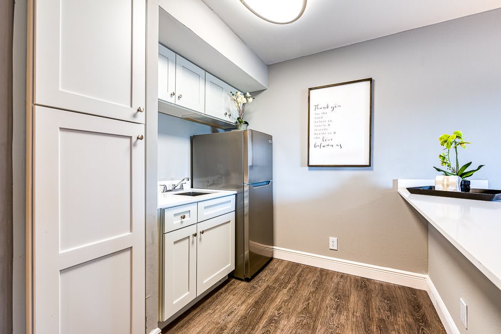 A modern laundry room with sleek cabinets and appliances.