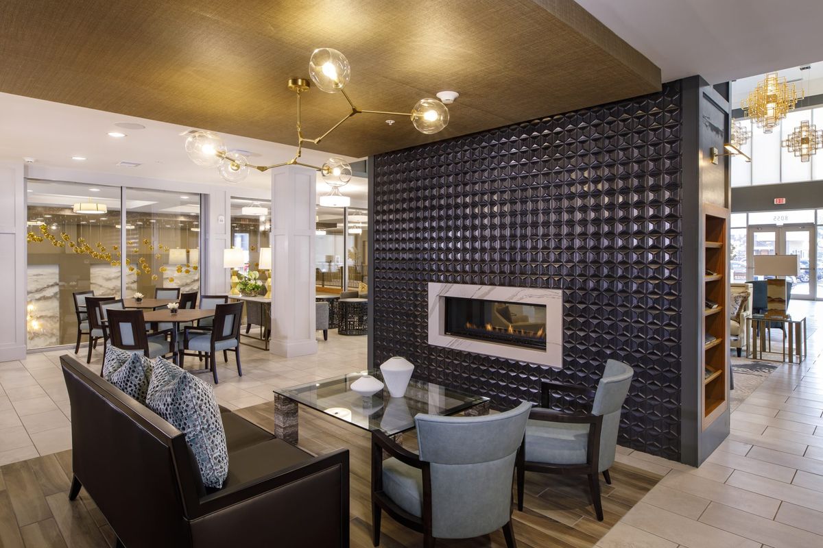 A modern living room with a sleek fireplace and stylish seating arrangement.
