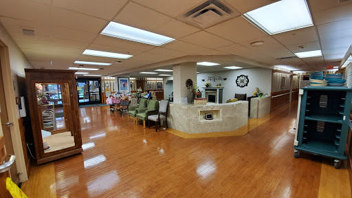 A spacious and welcoming waiting area in a medical facility, featuring comfortable seating and natural light.