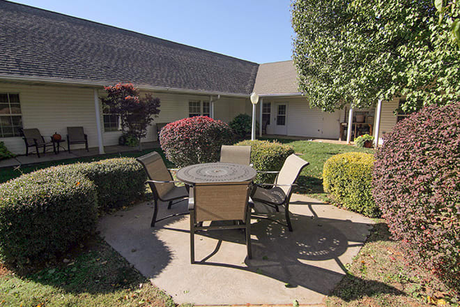 A peaceful courtyard with outdoor seating and well-maintained landscaping.