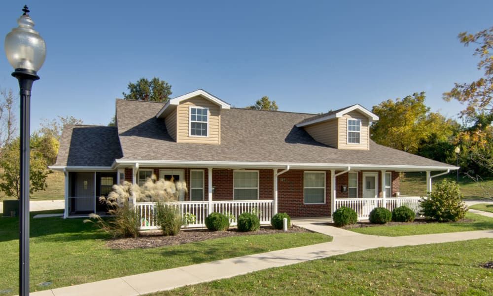 A suburban house with a well-maintained lawn and a welcoming porch.