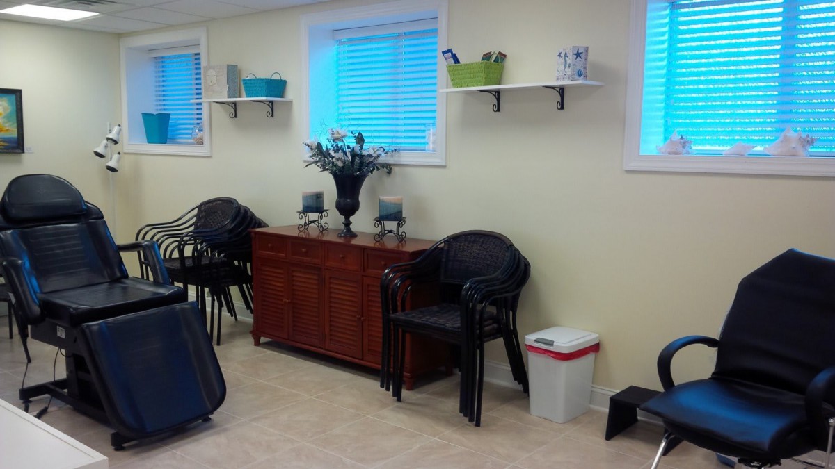 A cozy room with chairs, a table, and decorative elements under a window.