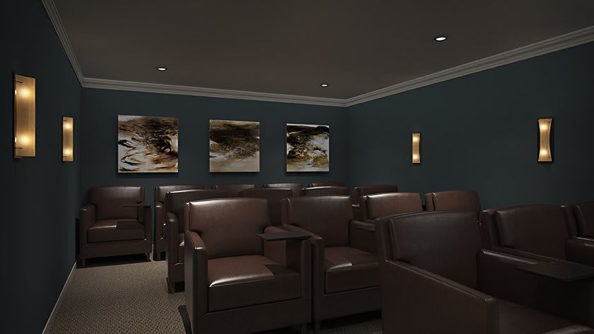 A modern home theater room with comfortable armchairs and stylish decor.
