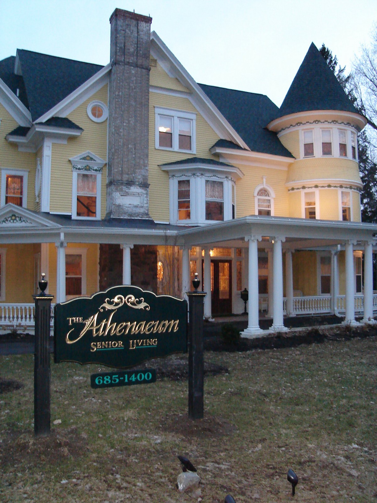 A Victorian-style bed and breakfast inn with a welcoming evening ambiance.