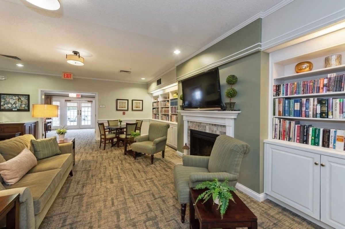 A cozy living room with a fireplace, TV, and comfortable seating.