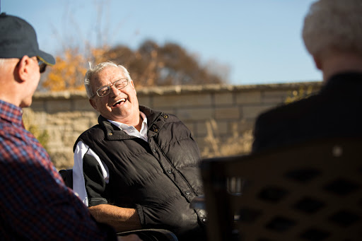 A joyful moment shared between friends in a sunny outdoor setting.