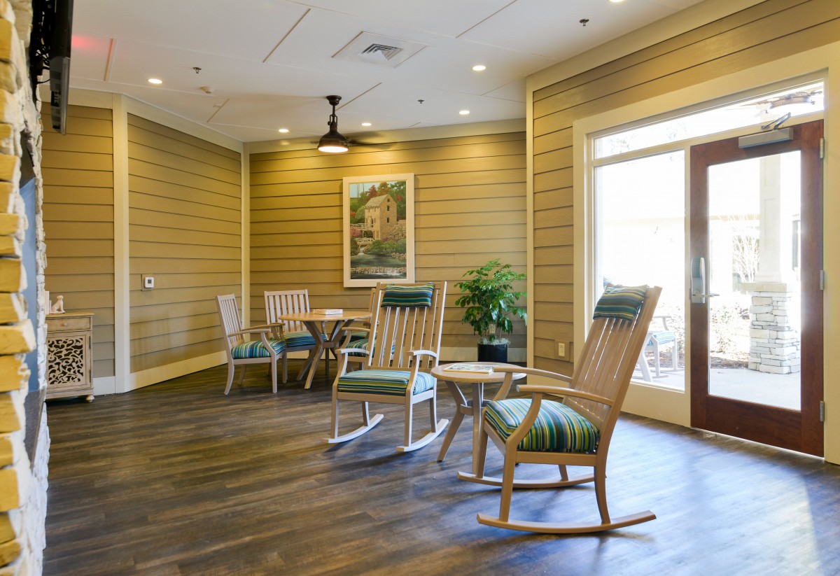 A cozy lounge area with rocking chairs and natural lighting.