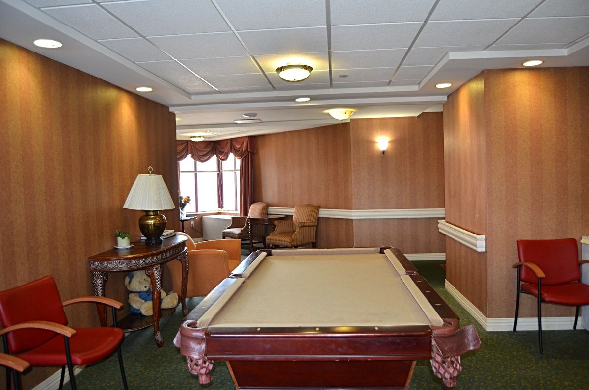 A cozy recreation room with a pool table and seating area.